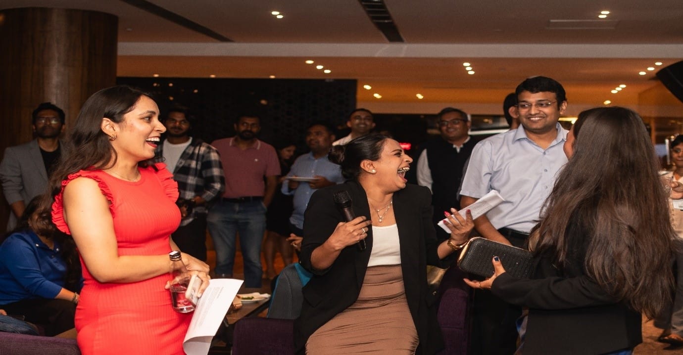 A group of people laughing
Description automatically generated